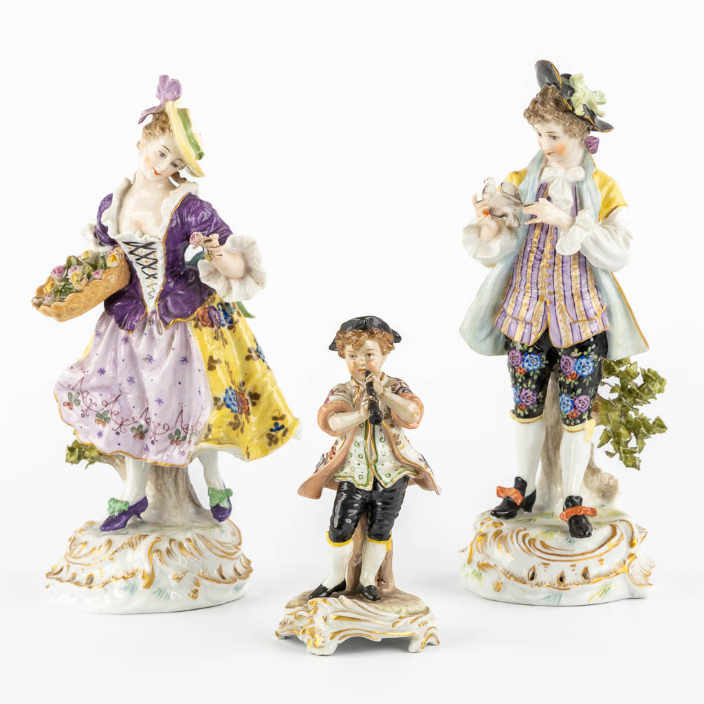 A pair of polychrome porcelain figurines, added A Saxony porcelain boy. (H:23,5 cm)