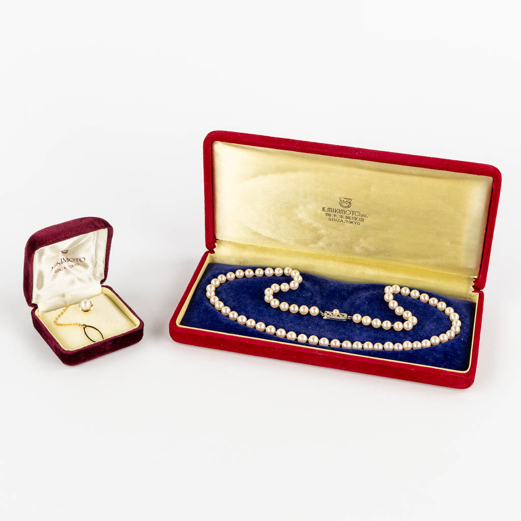 Mikimoto, a pearl necklace and tie clasp, 14kt white and yellow gold, 1965. 