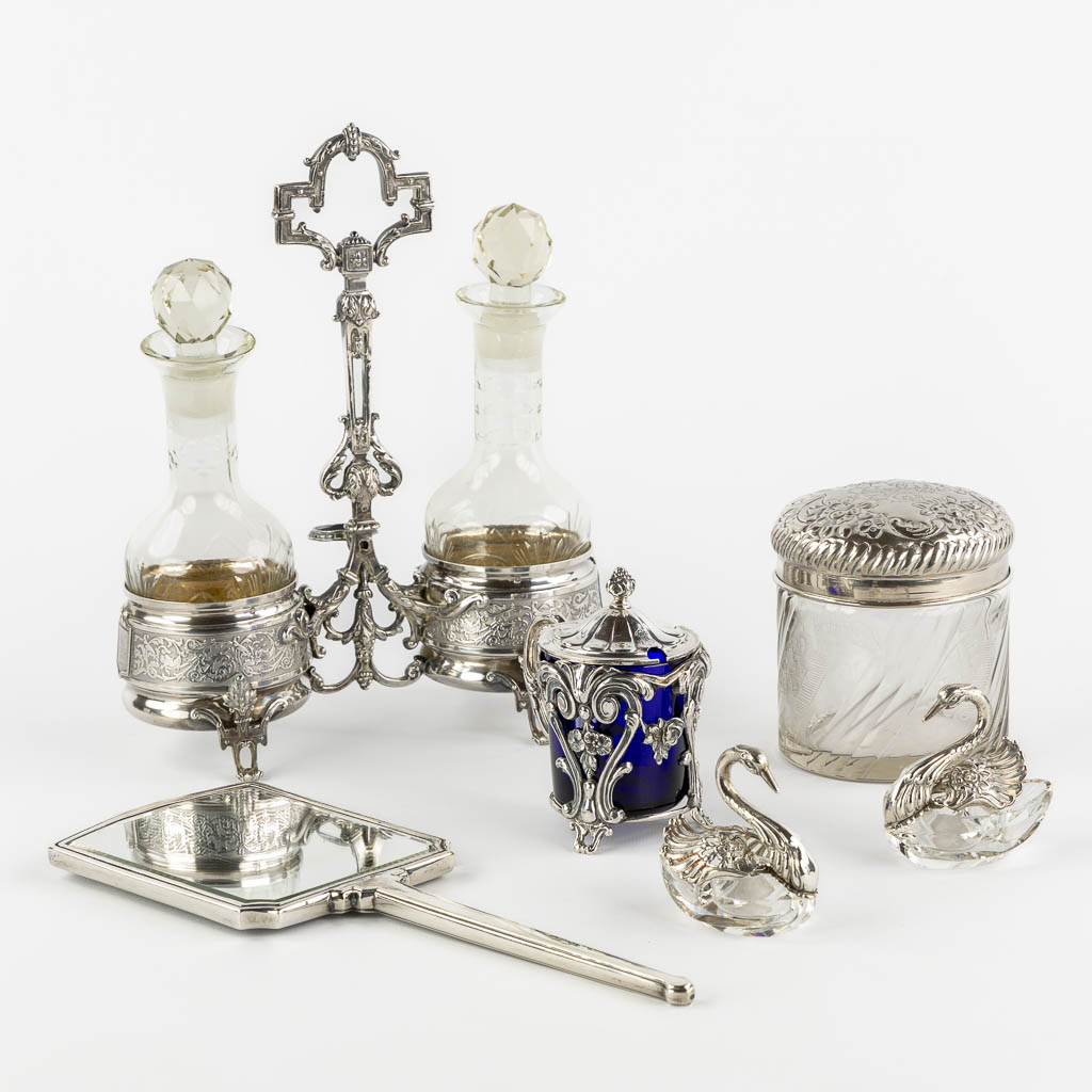 A collection of silver table accessories, oil/vinegar, salt/pepper, mustard pot, and mirror. (L:9 x W:21 x H:26 cm)