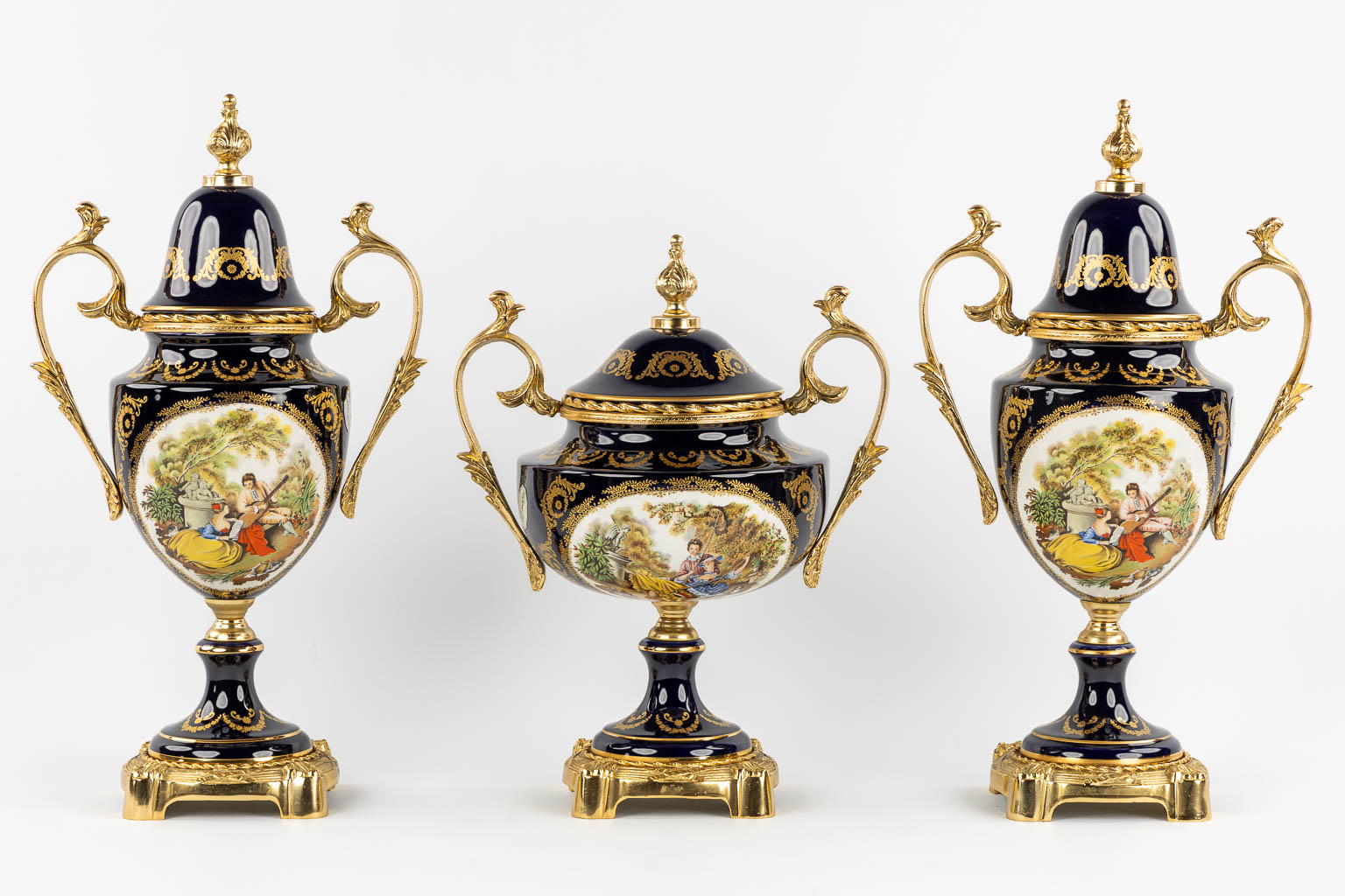 Limoges, a three-piece mantel garniture, porcelain mounted with bronze. 20th C.