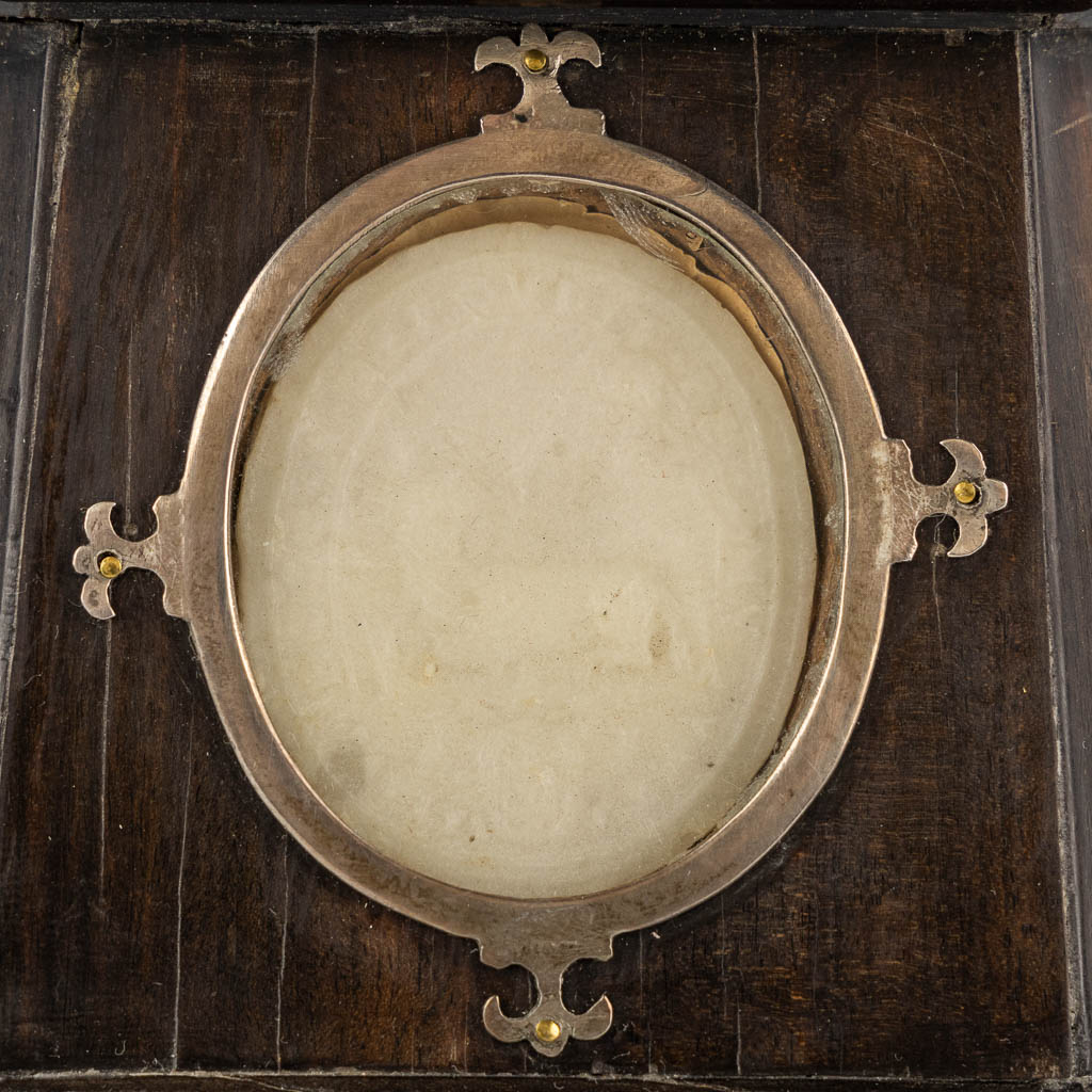 A large reliquary crucifix with 9 relics and an Agnus Dei, ebonised wood and silver-plated metal. 19th C.