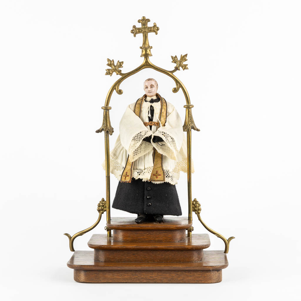 A shrine with a wax figurine of a saint, circa 1920. Gothic Revival. (L:14 x W:20 x H:33 cm)