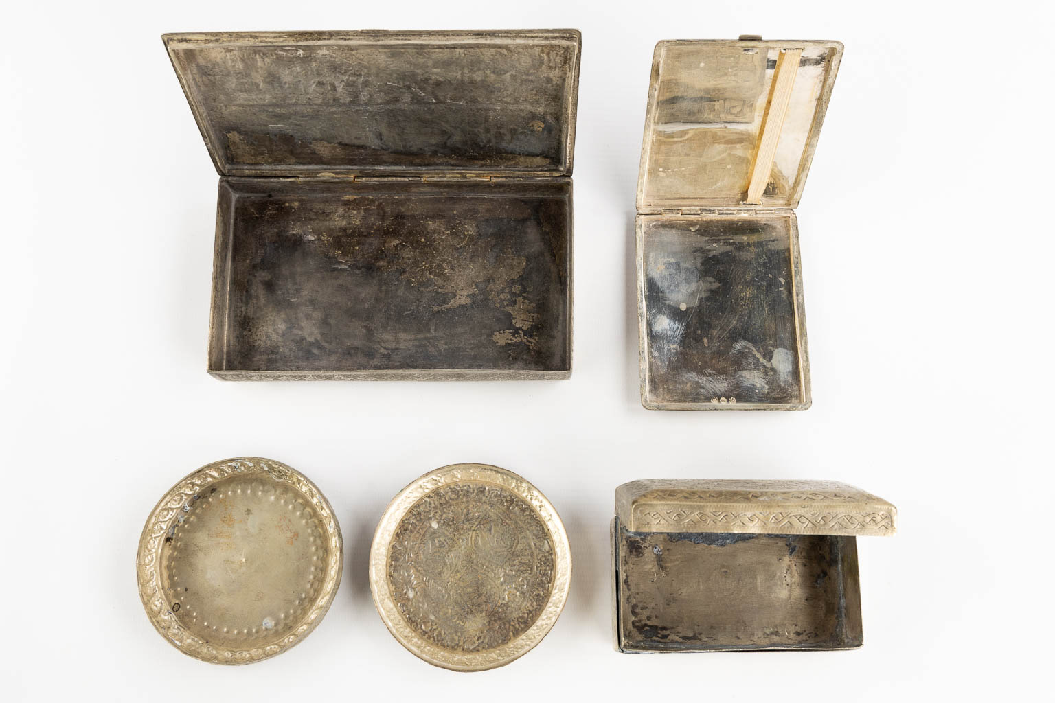 Fourteen Islamic and Indian Amulet or Trinklet boxes, Silver and silver-plate. 19th/20th C. (L:9,5 x W:16,5 x H:2,5 cm)