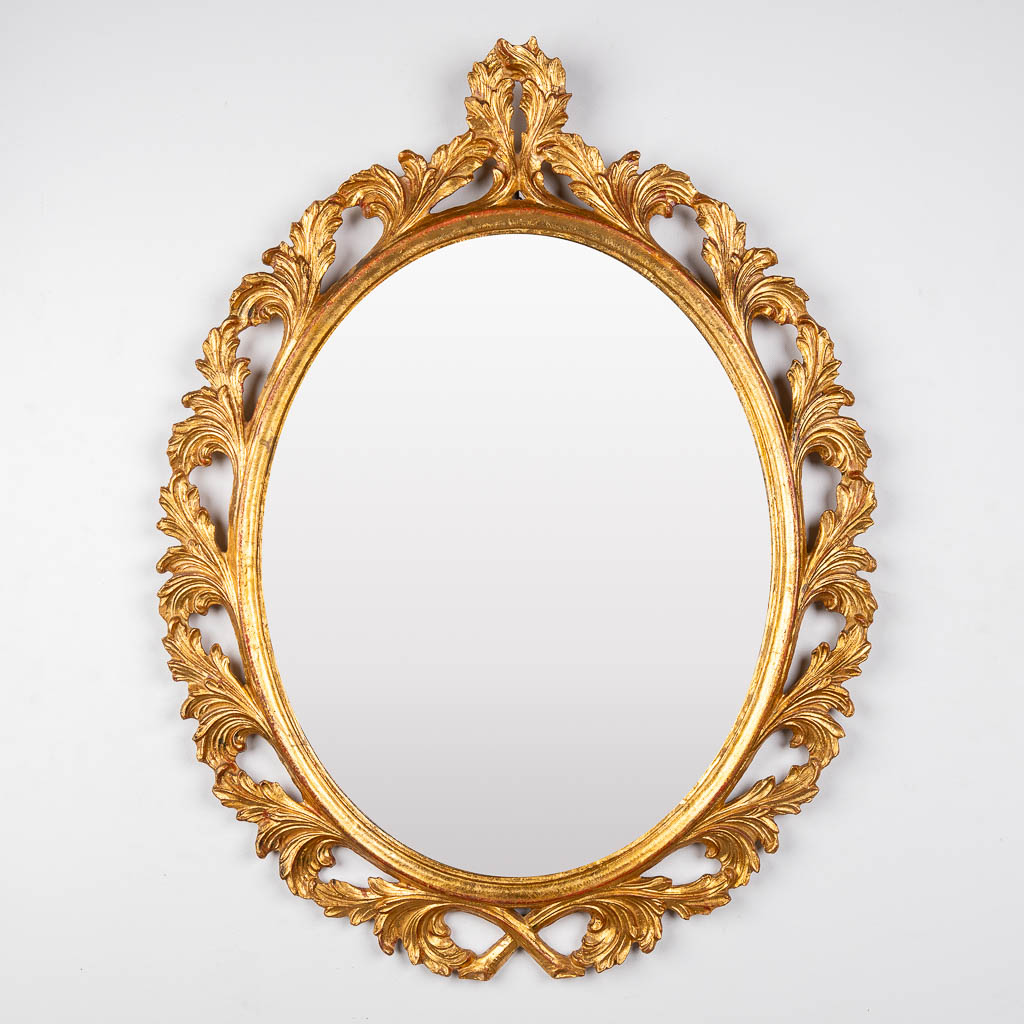 A wood-sculptured oval mirror, circa 1960. (W:73 x H:94 cm)