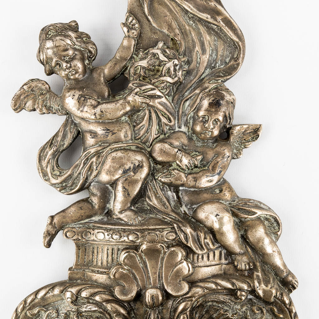 A holy water font in Baroque style, Angel figurines and a crucifix. Silver-plated bronze. 19th C.