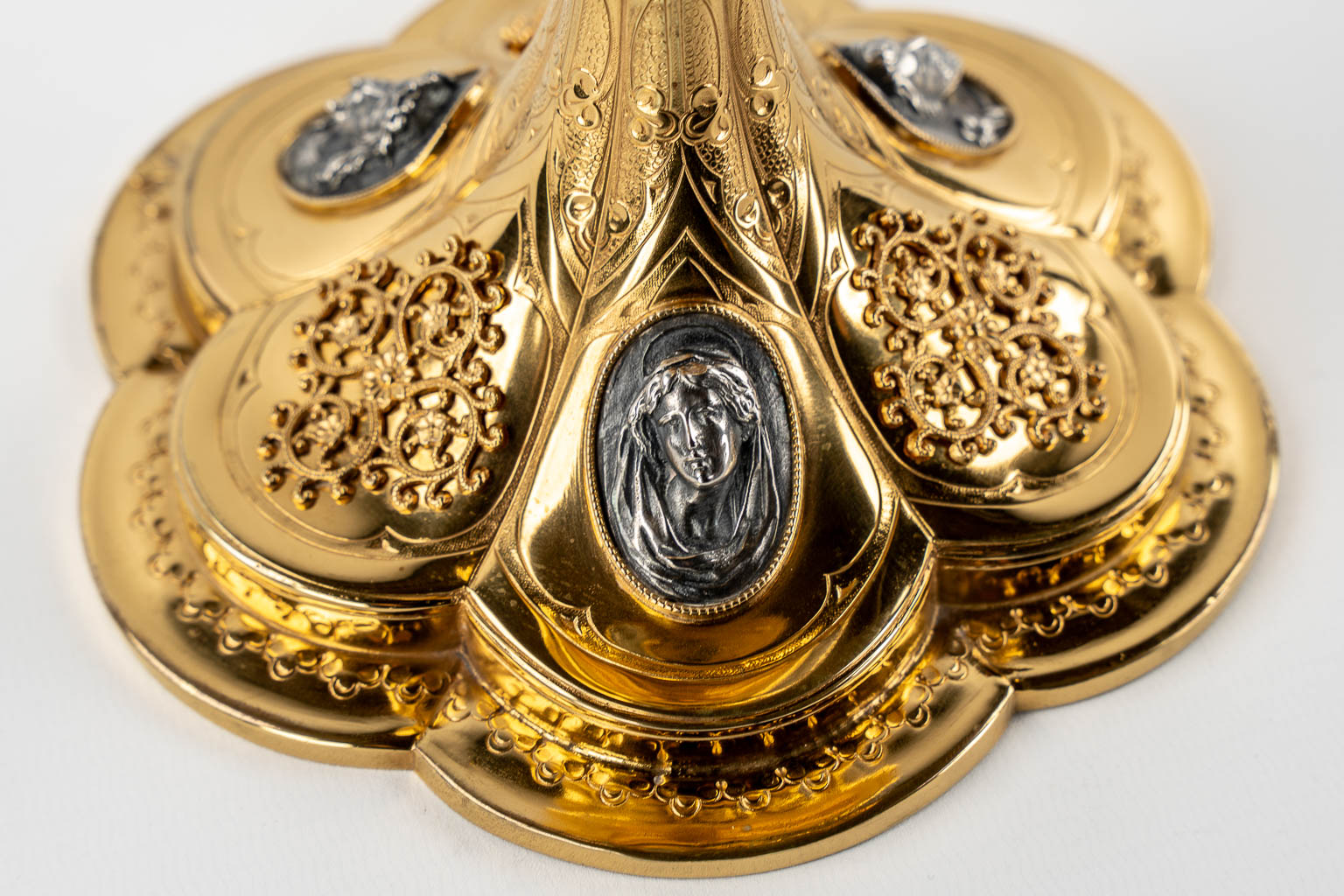 A Gothic Revival chalice with enamel plaques, cabochons. Silver Cuppa, Gilt brass, 19th C.