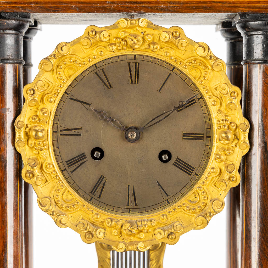 A column clock, marquetry inlay and gilt bronze. 19th C. (L:15 x W:25 x H:46 cm)