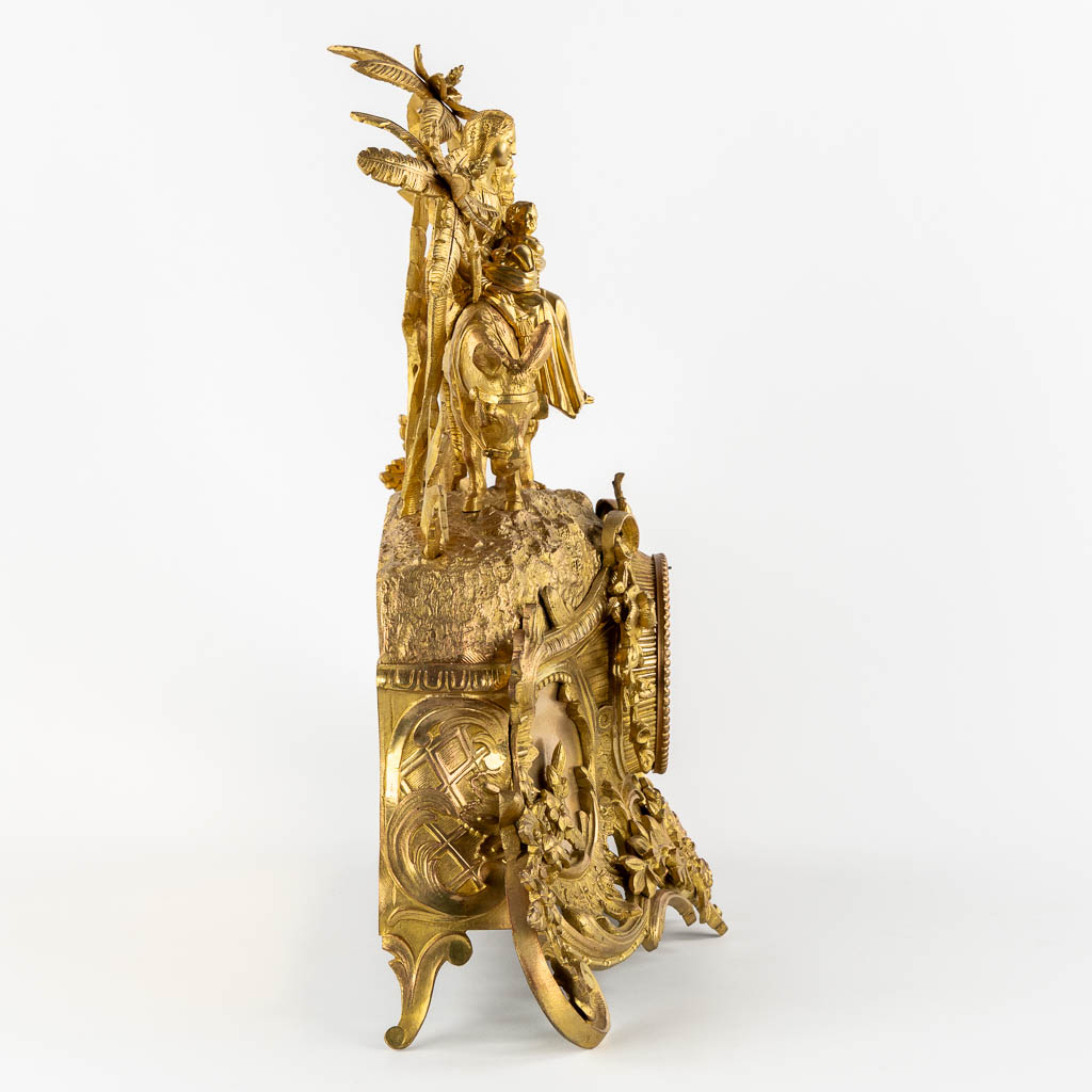 A mantle clock gilt bronze 'The Flight into Egypt'. 19th C.