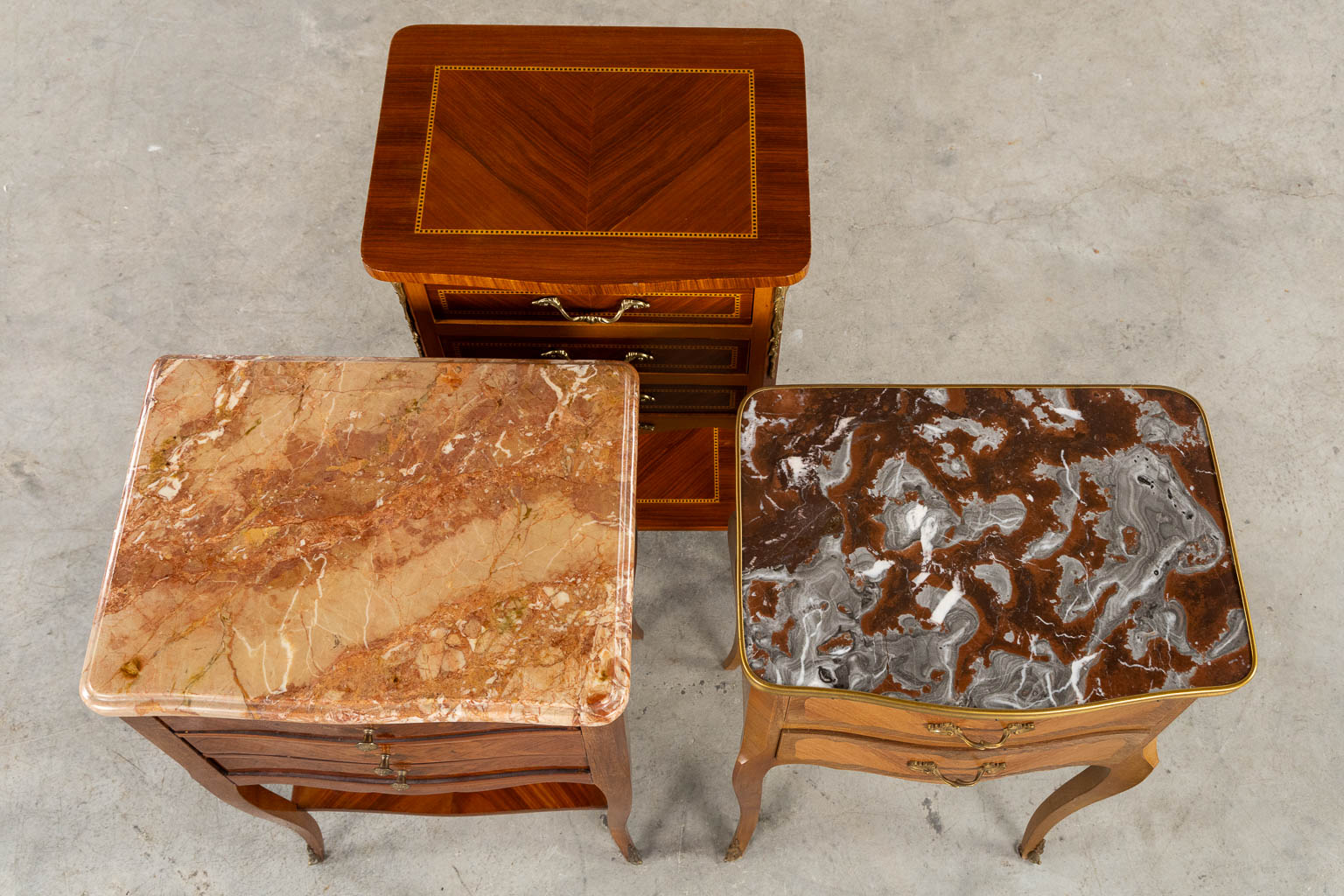 Three side tables, marquetry inlay. Two with a marble top. Circa 1980. (L:33 x W:42 x H:70 cm)