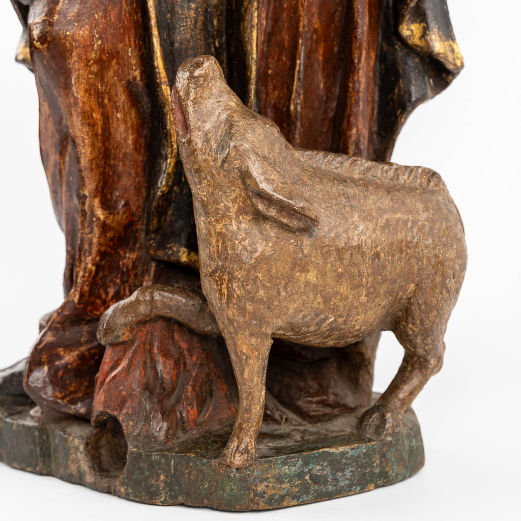 An antique wood-sculptured figurine of Saint Anthony the Great, with a pig. 18th C.