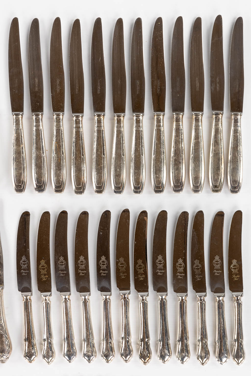 Twelve sets of twelve silver-plated knives. 