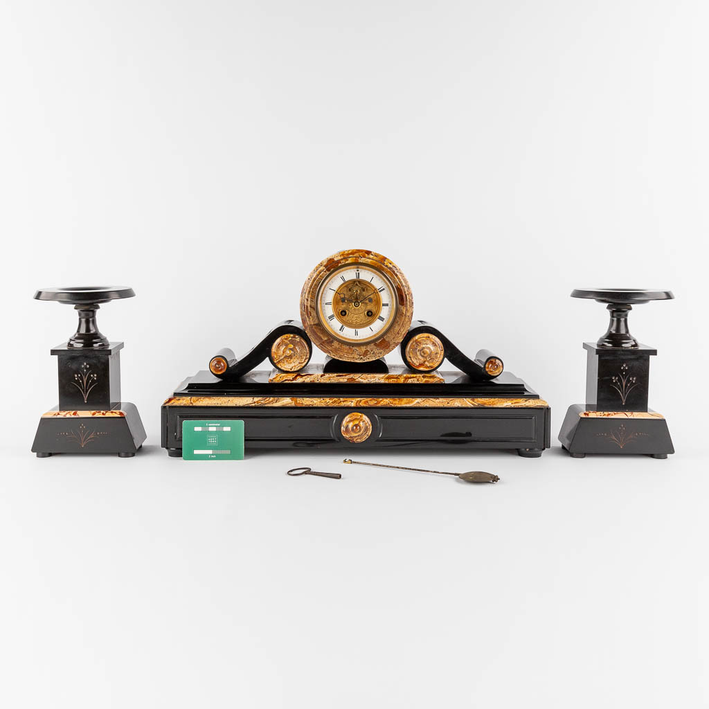 A three-piece mantle garniture clock and side pieces, marble. Circa 1900. (L:15 x W:54 x H:30 cm)