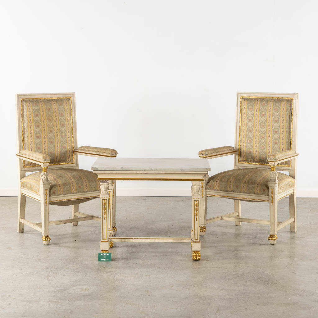 A pair of armchairs and side table, sculptured wood in Empire style. Italy, circa 1920. (L:54 x W:62 x H:105 cm)