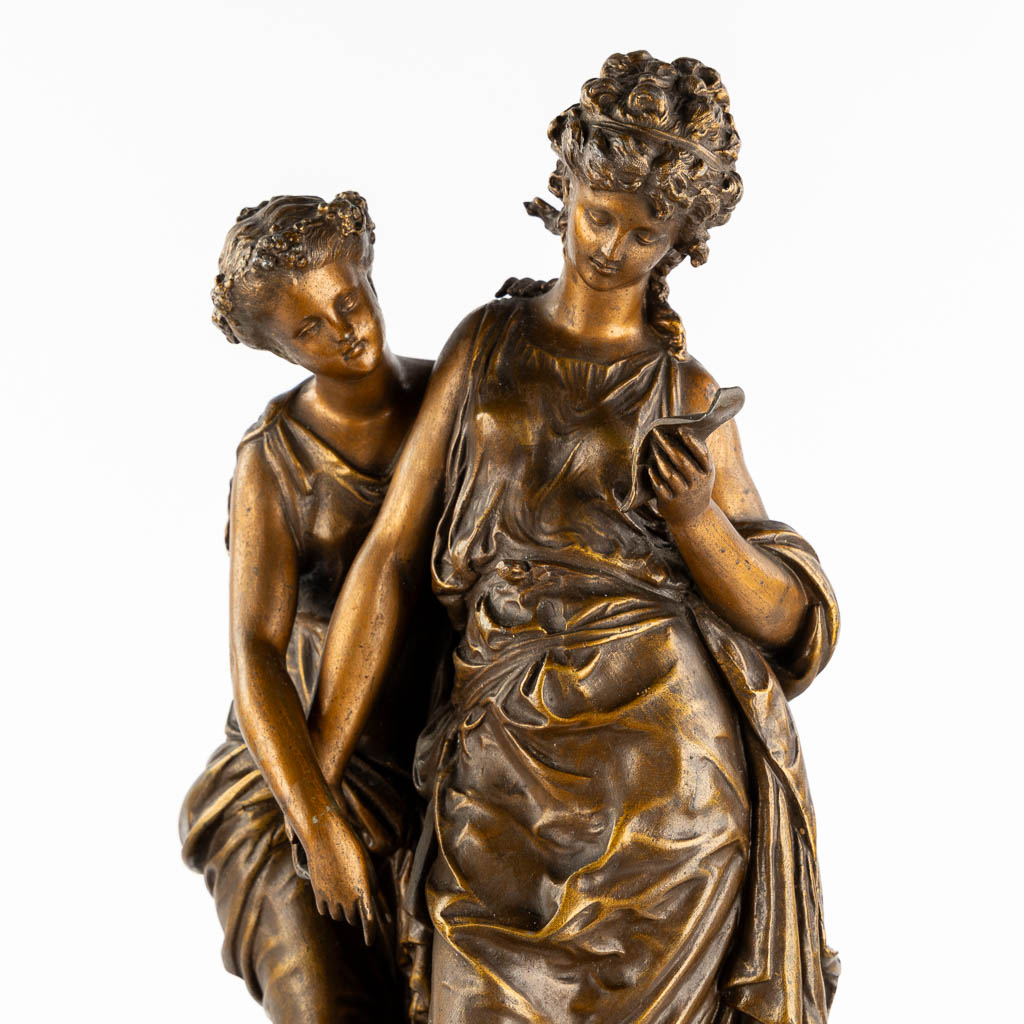 A large mantle clock with two ladies, patinated spelter. Circa 1900. (L:18 x W:42 x H:58 cm)