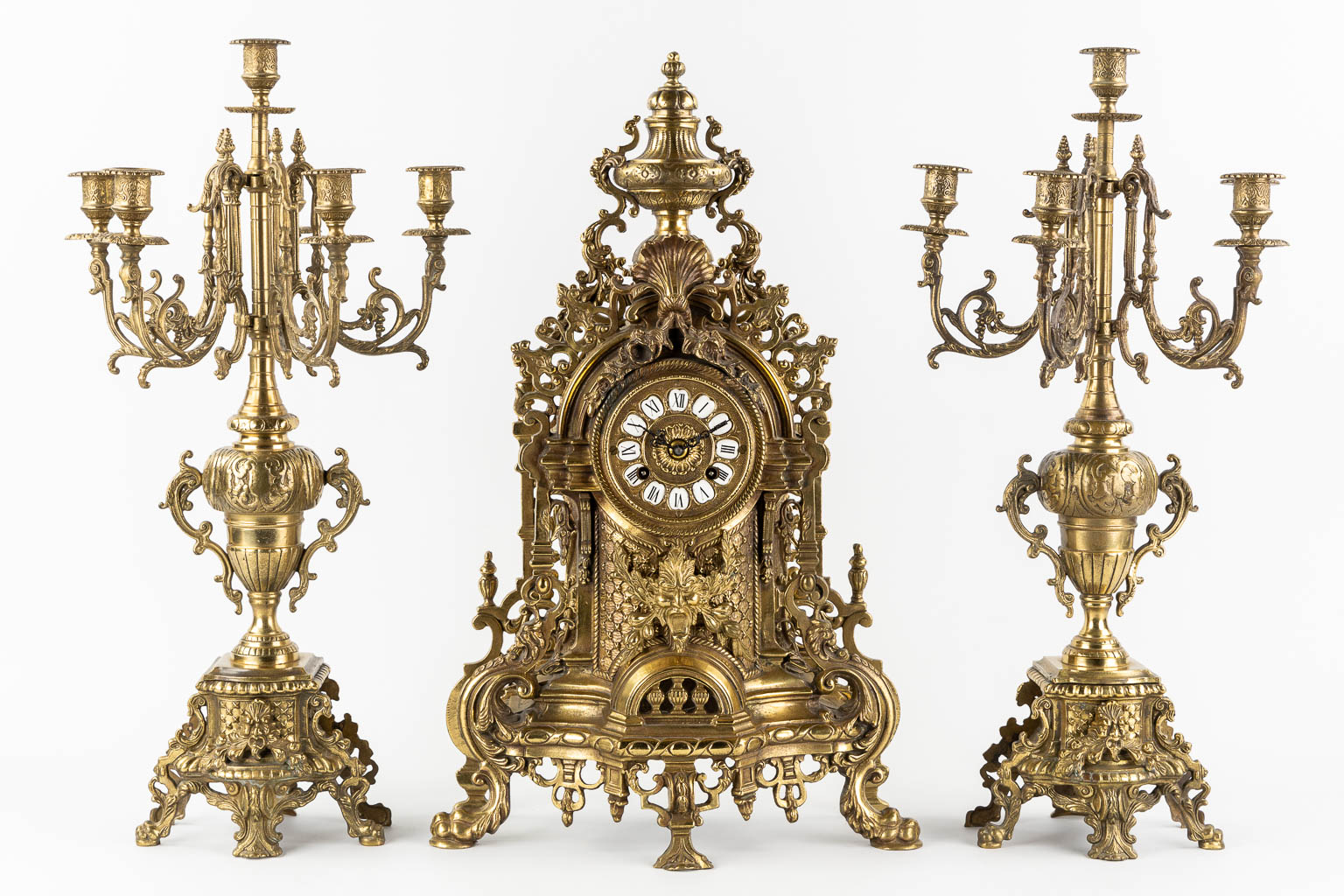 A large three-piece mantle garniture clock, polished bronze. Circa 1970.