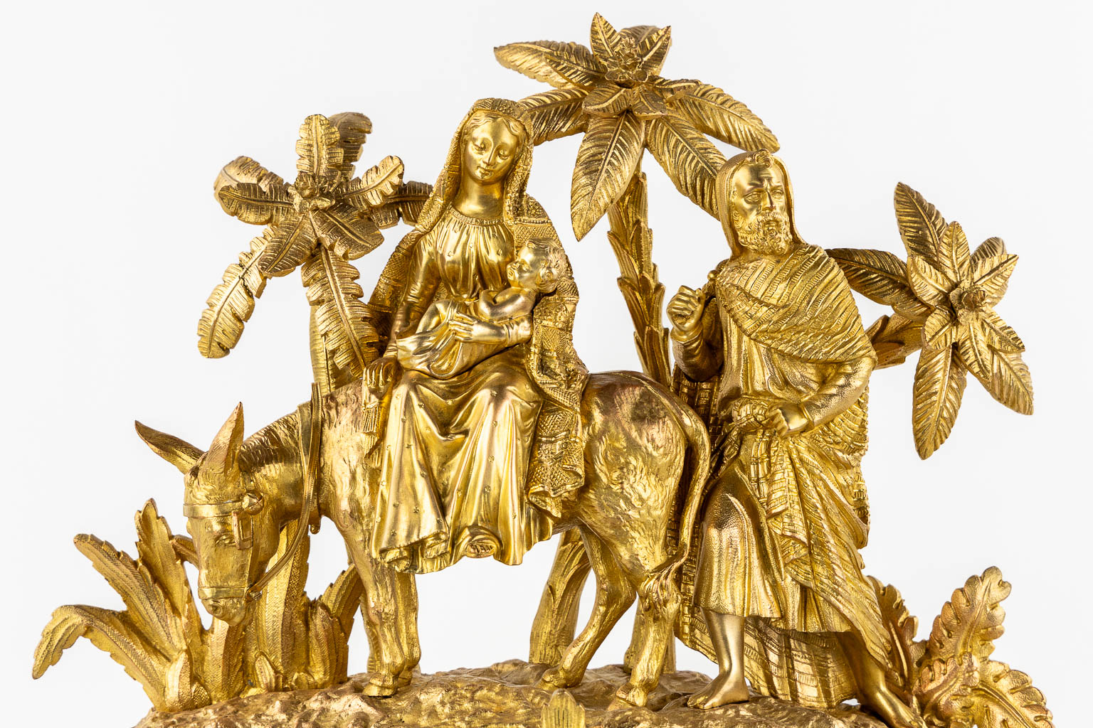 A mantle clock gilt bronze 'The Flight into Egypt'. 19th C.