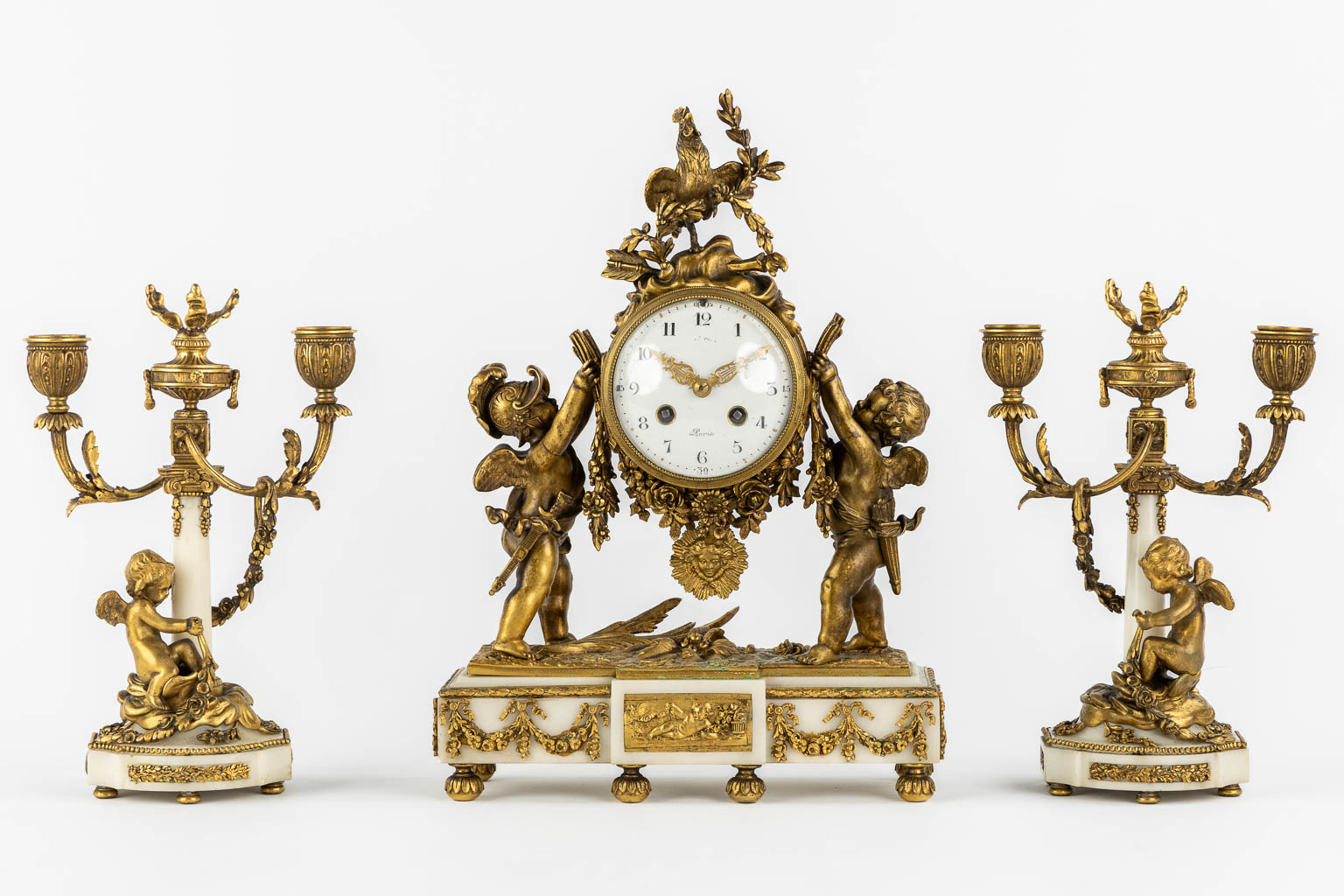 A three-piece mantle garniture clock and candelabra, bronze and marble, 19th C. (L:11 x W:27 x H:36 cm)