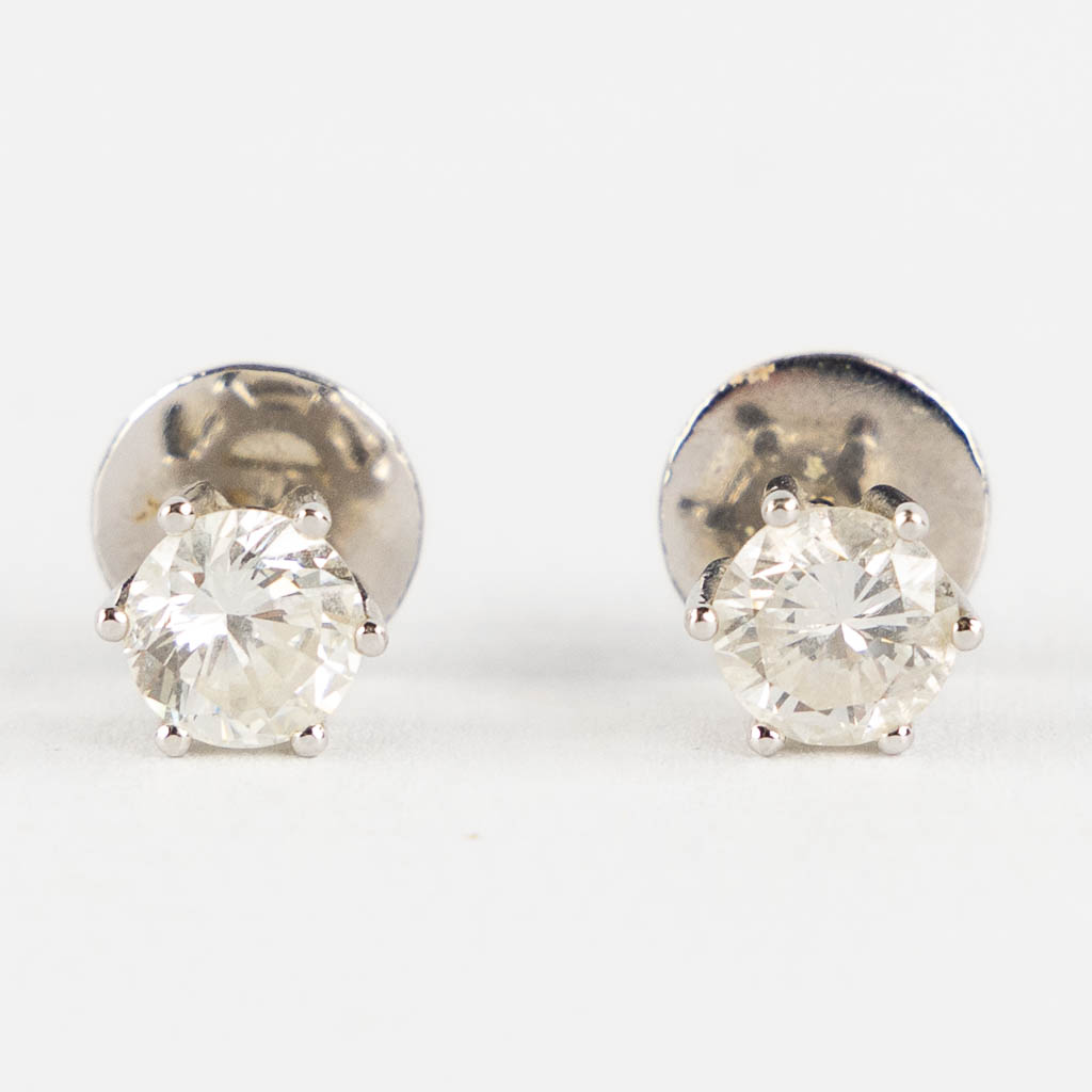 A pair of earrings each with diamond of approximately 1ct. 18kt white gold. 