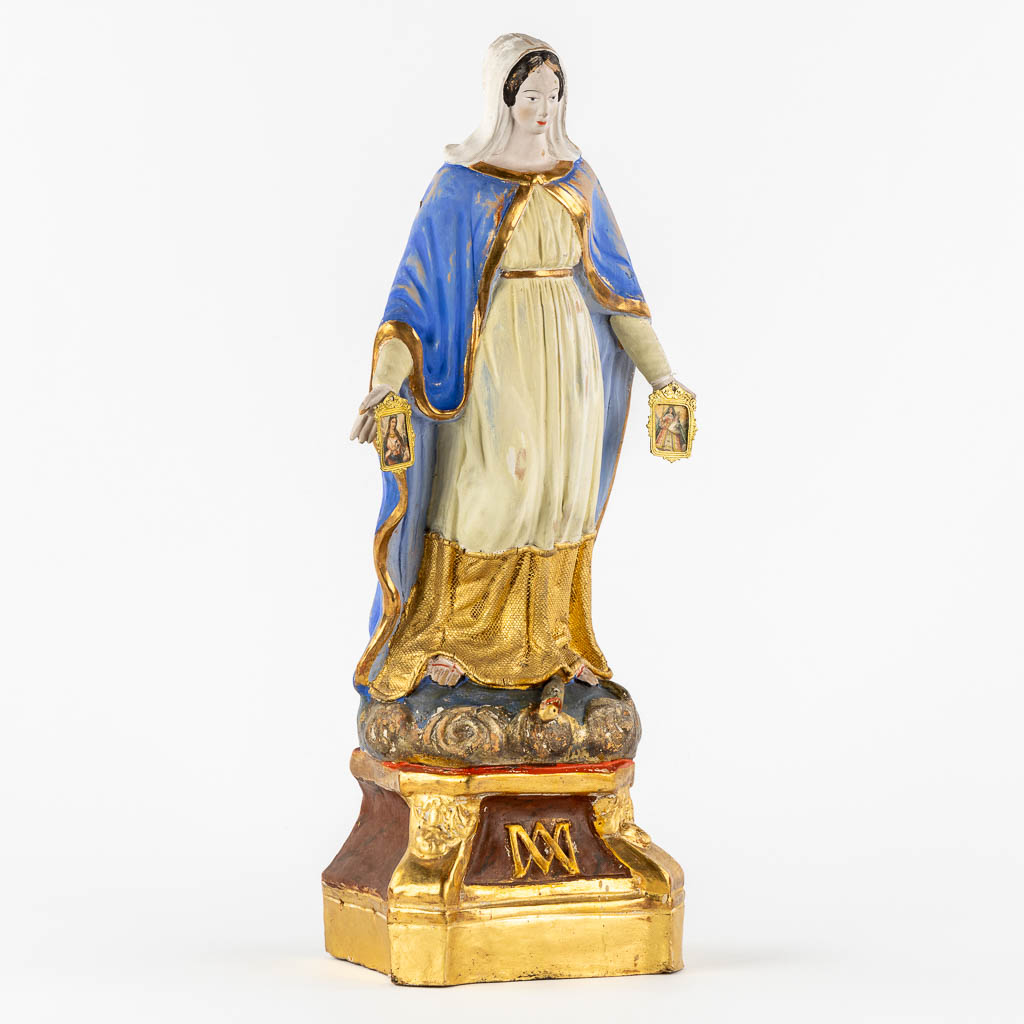 A patinated terracotta figurine of The Virgin Mary. (c1900)