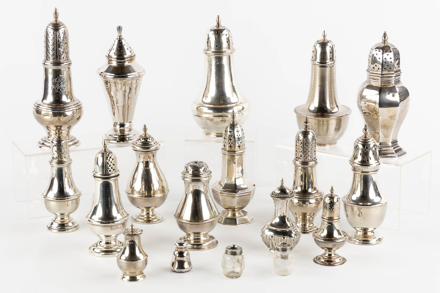 A large collection of silver sugar casters, pepper and salt jars. UK. (H:19,5 cm)