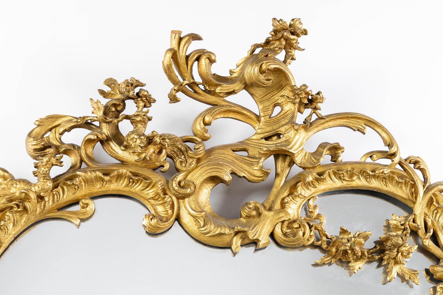 An antique wood-sculptured mirror, Louis XV style. Circa 1900. (W:93 x H:135 cm)