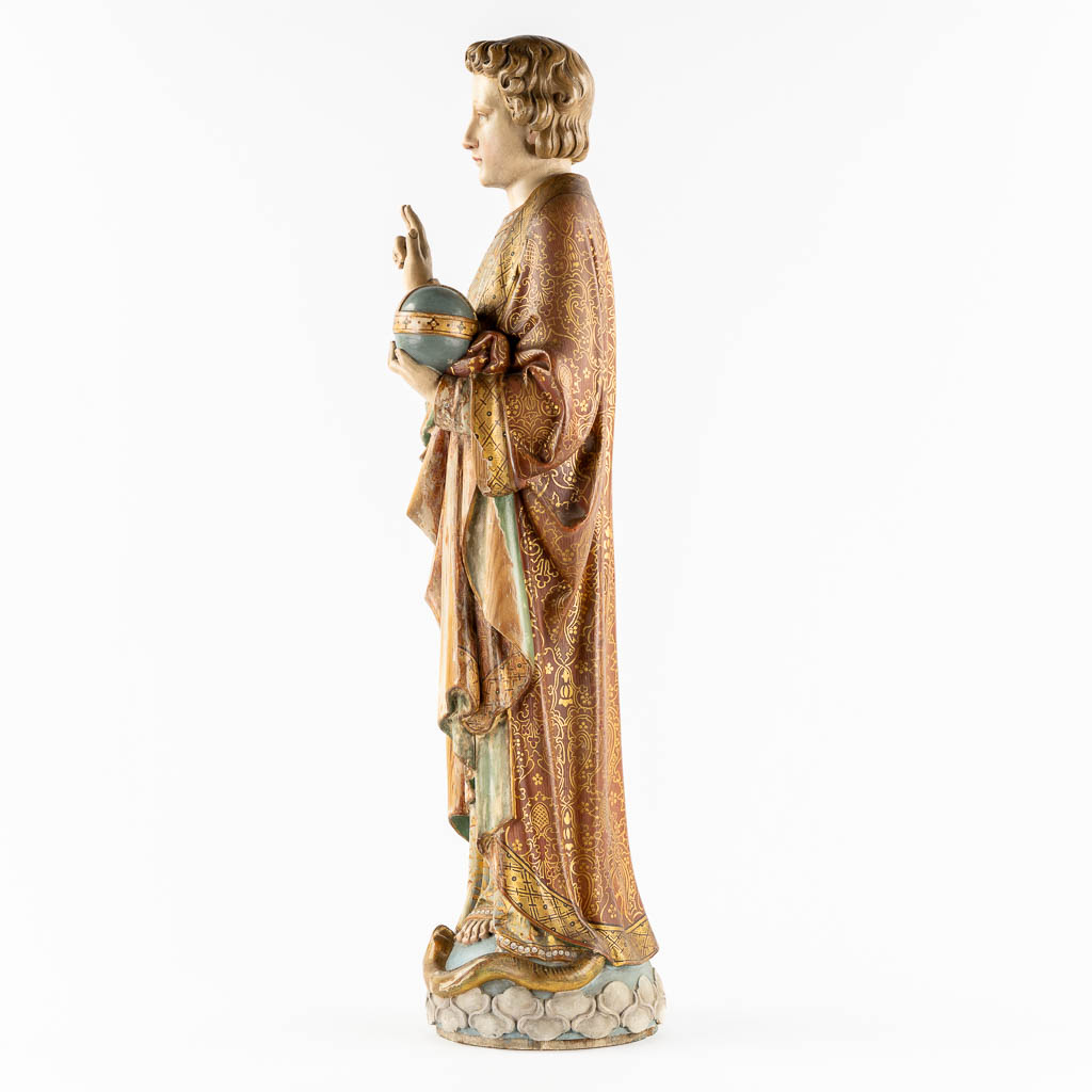 An antique wood-sculptured figurine of Salvator Mundi, holding a globus cruciger and serpent. 19th C. (L:22 x W:27 x H:87 cm)