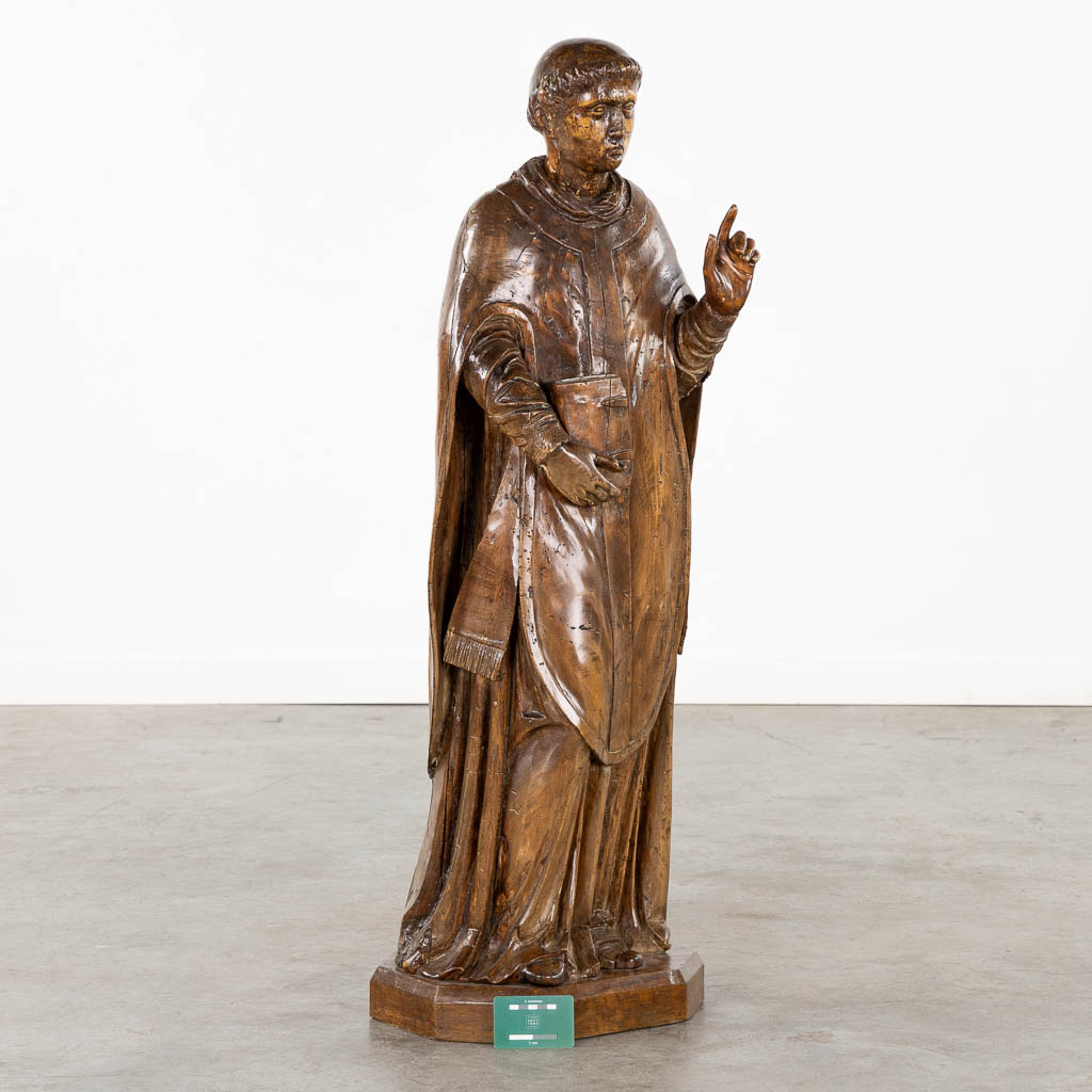 An antique wood-sculptured figurine of Saint Lawrence, 18th/19th C. (L:27 x W:33 x H:106 cm)