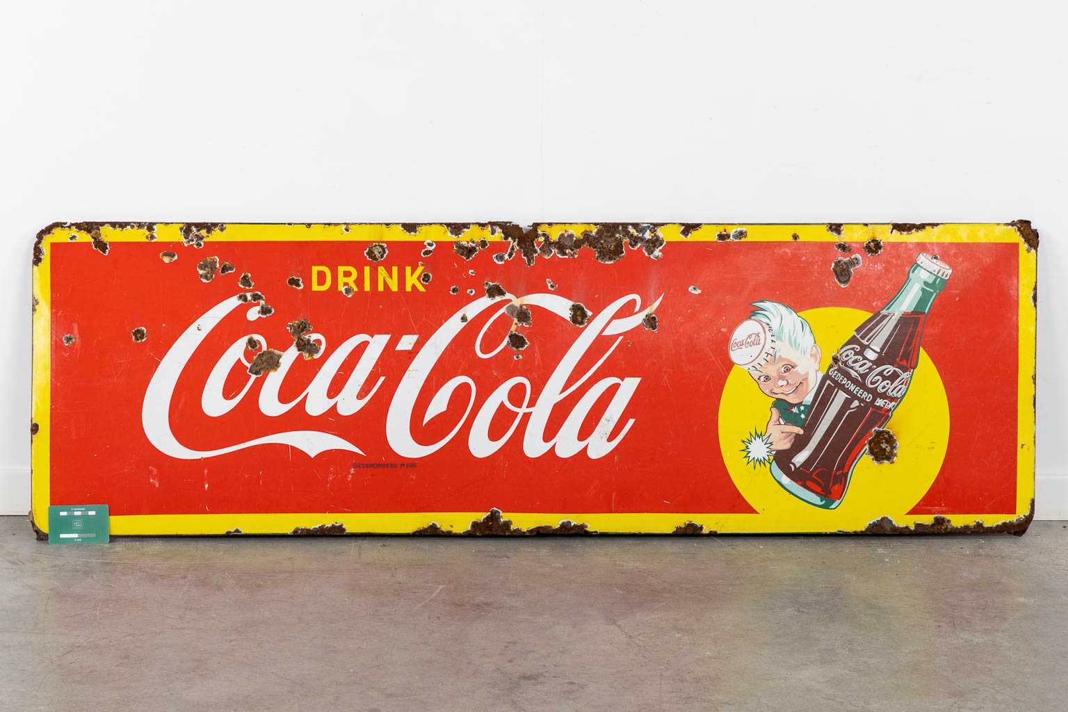 "Drink Coca Cola", a large enamel advertising board, 1957. (W:145 x H:46 cm)