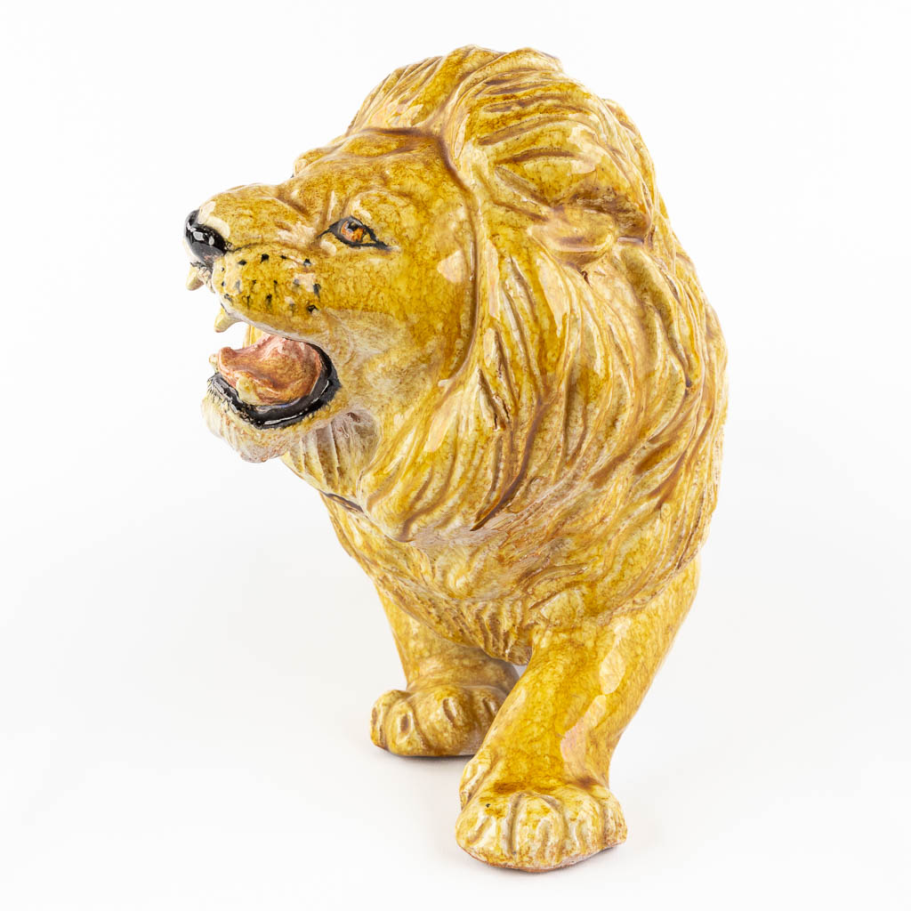 A decorative lying lion, glazed terracotta. Italy, circa 1960-1970. 