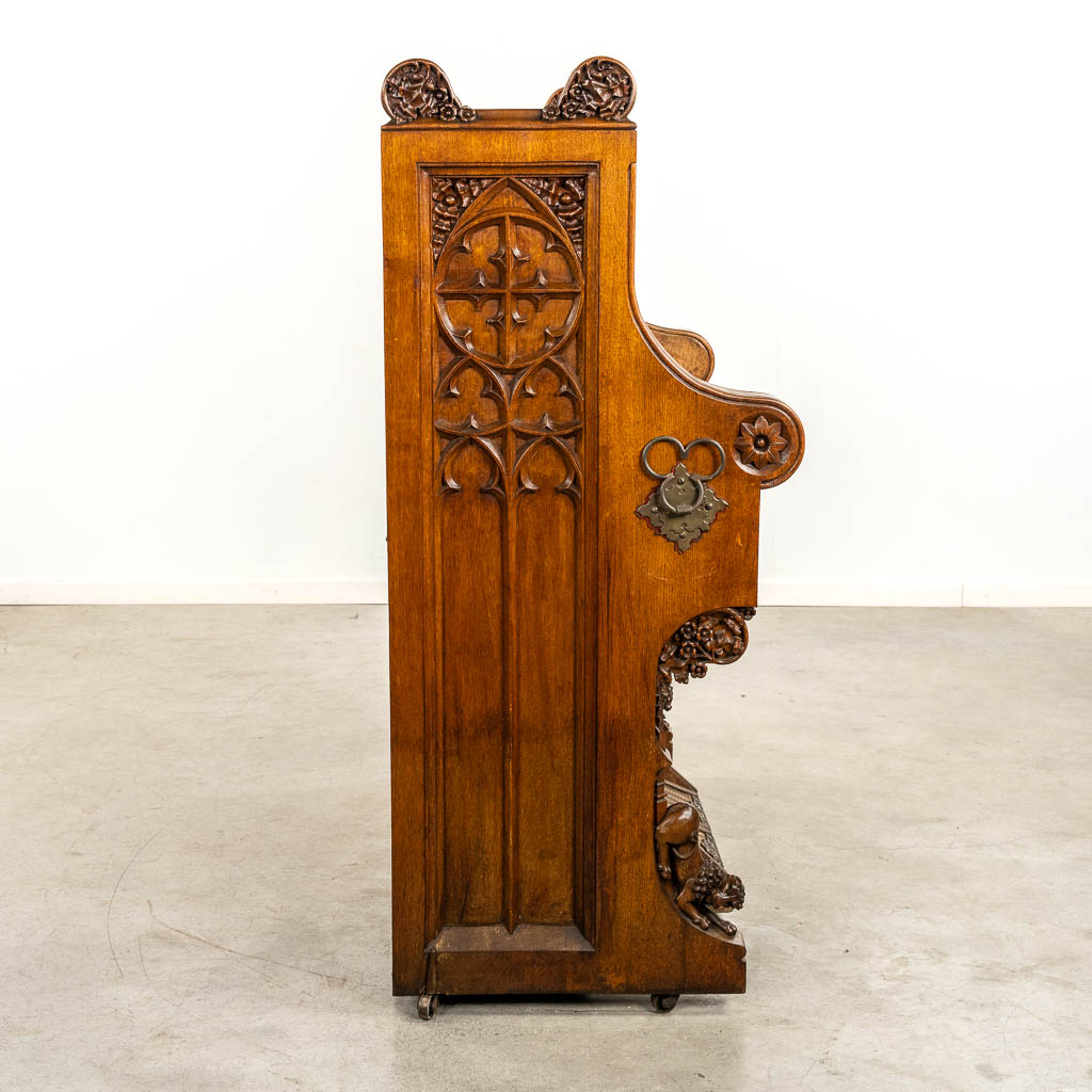 An antique organ, sculptured wood in Gothic Revival style. Circa 1900.