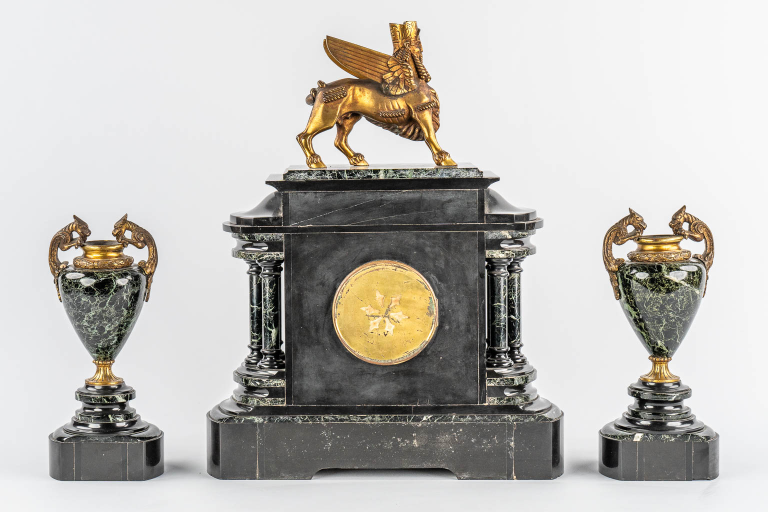 A Neoclassical three-piece mantle garniture clock and side pieces, marble and bronze. 19th C.