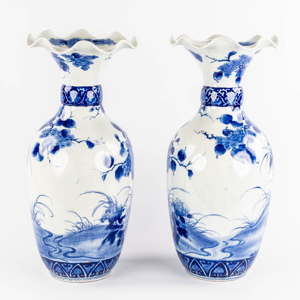 A pair of Japanese vases, Blue-white with a floral decor. 