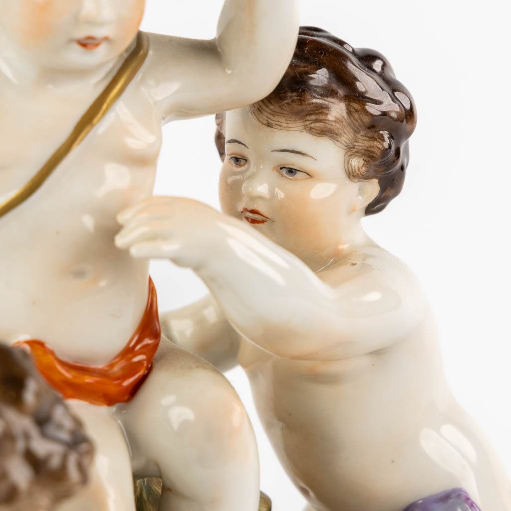 Volkstedt, Rudolstadt, a polychrome porcelain group with putti. (L:12,5 x W:23,5 x H:24 cm)