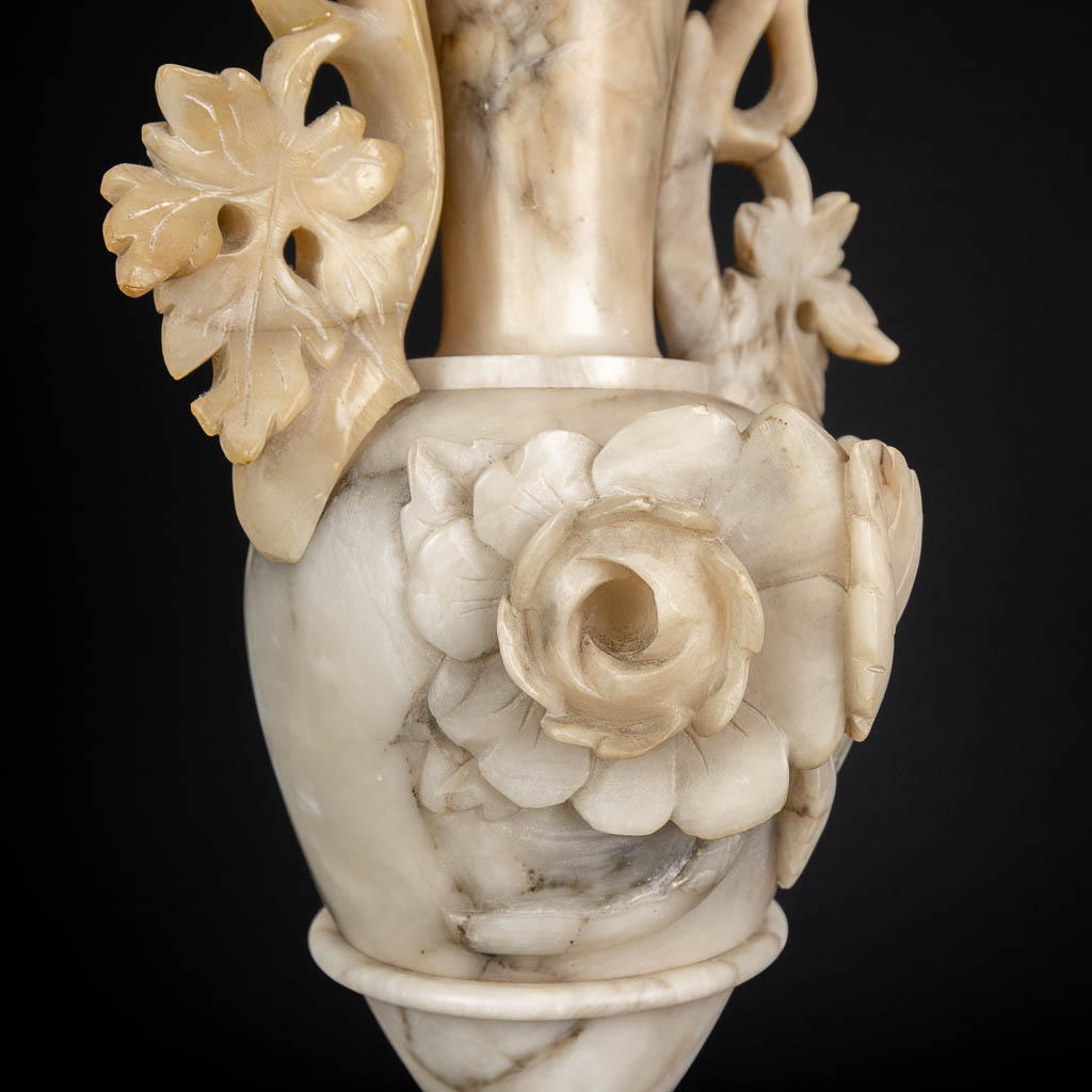 A three piece mantle garniture set, sculptured alabaster. (H:45 x D:15 cm)