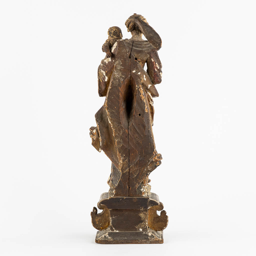 An antique wood-sculptured figurine of Madonna with a Child. 17th/18th C. (L:11,5 x W:16 x H:45 cm)