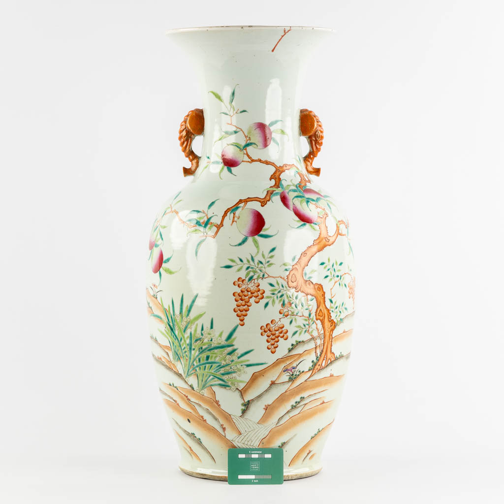 A large Chinese Famille Rose vase with a peach decor and elephant handles. 19th C. (H:70 x D:34 cm)