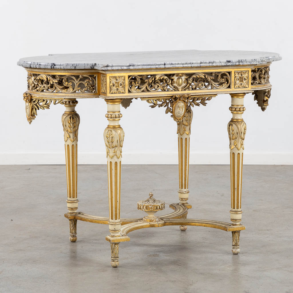 A wood-sculptured and patinated table with a grey marble, Louis XVI style. (L:65 x W:112 x H:80 cm)