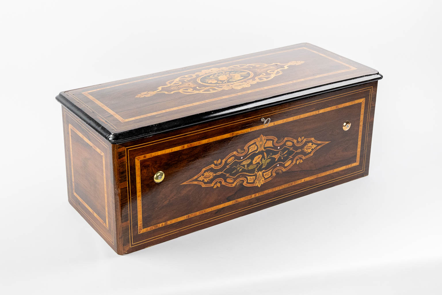 A large music box with an internal organ, in a marquetry inlay box. (L:30 x W:71 x H:27 cm)