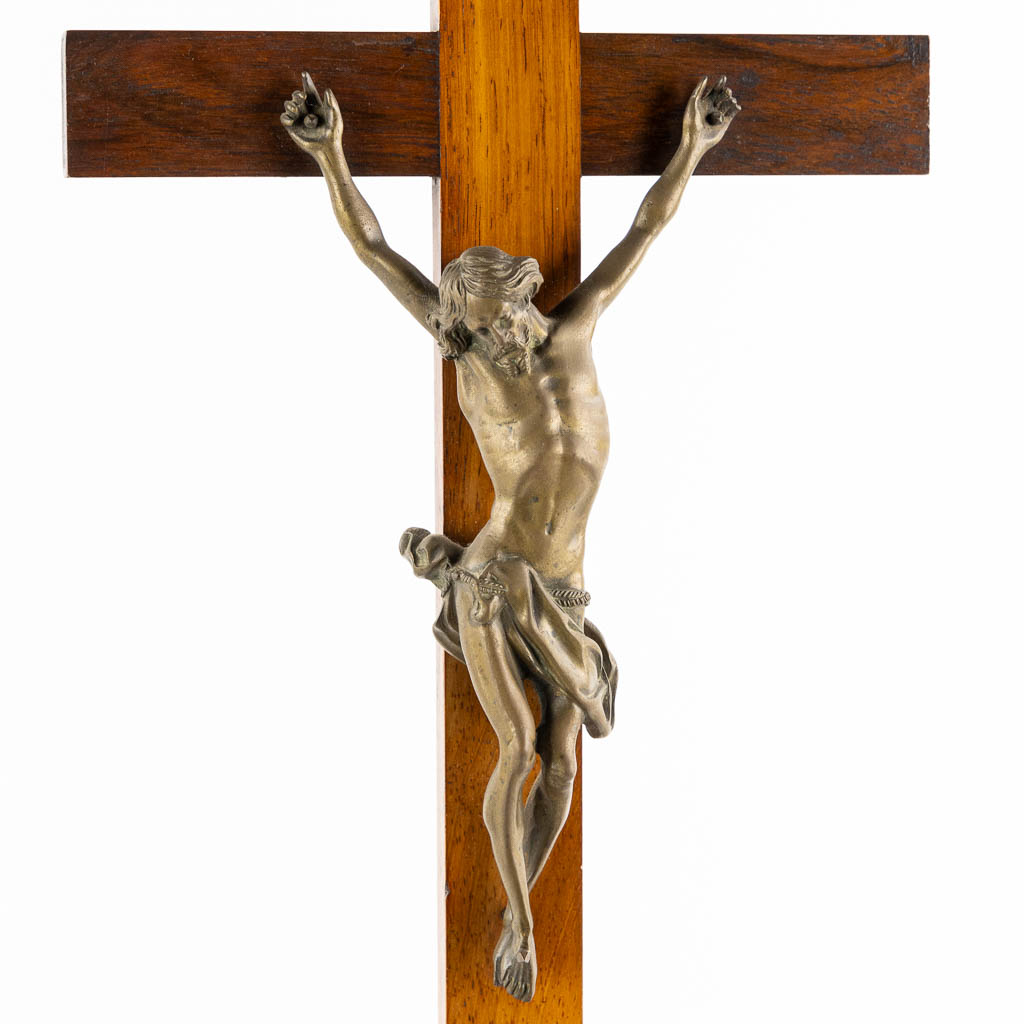 A bronze Corpus Christi mounted on a mahogany and marquetry inlay crucifix.