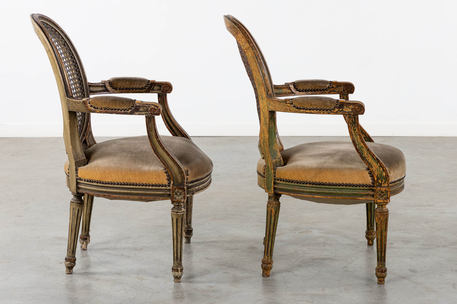 A pair of antique patinated chairs, Louis XVI style. (L:58 x W:57 x H:83 cm)