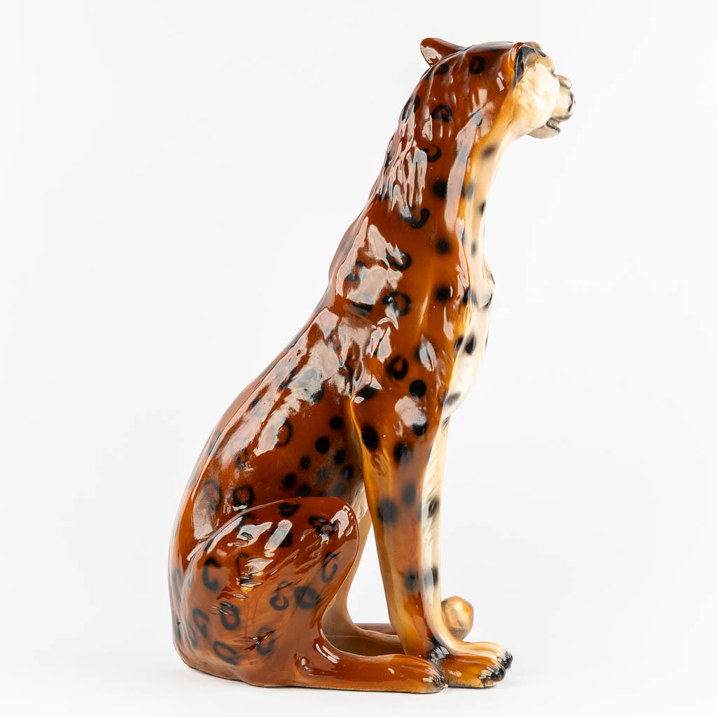 A decorative figurine of a leopard, patinated resine. 