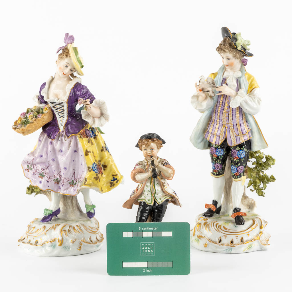 A pair of polychrome porcelain figurines, added A Saxony porcelain boy. (H:23,5 cm)