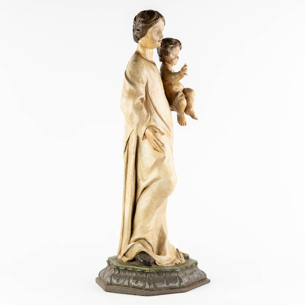 A wood-sculptured and patinated figurine of Madonna with a child. 18th C. (L:33 x W:34 x H:90 cm)