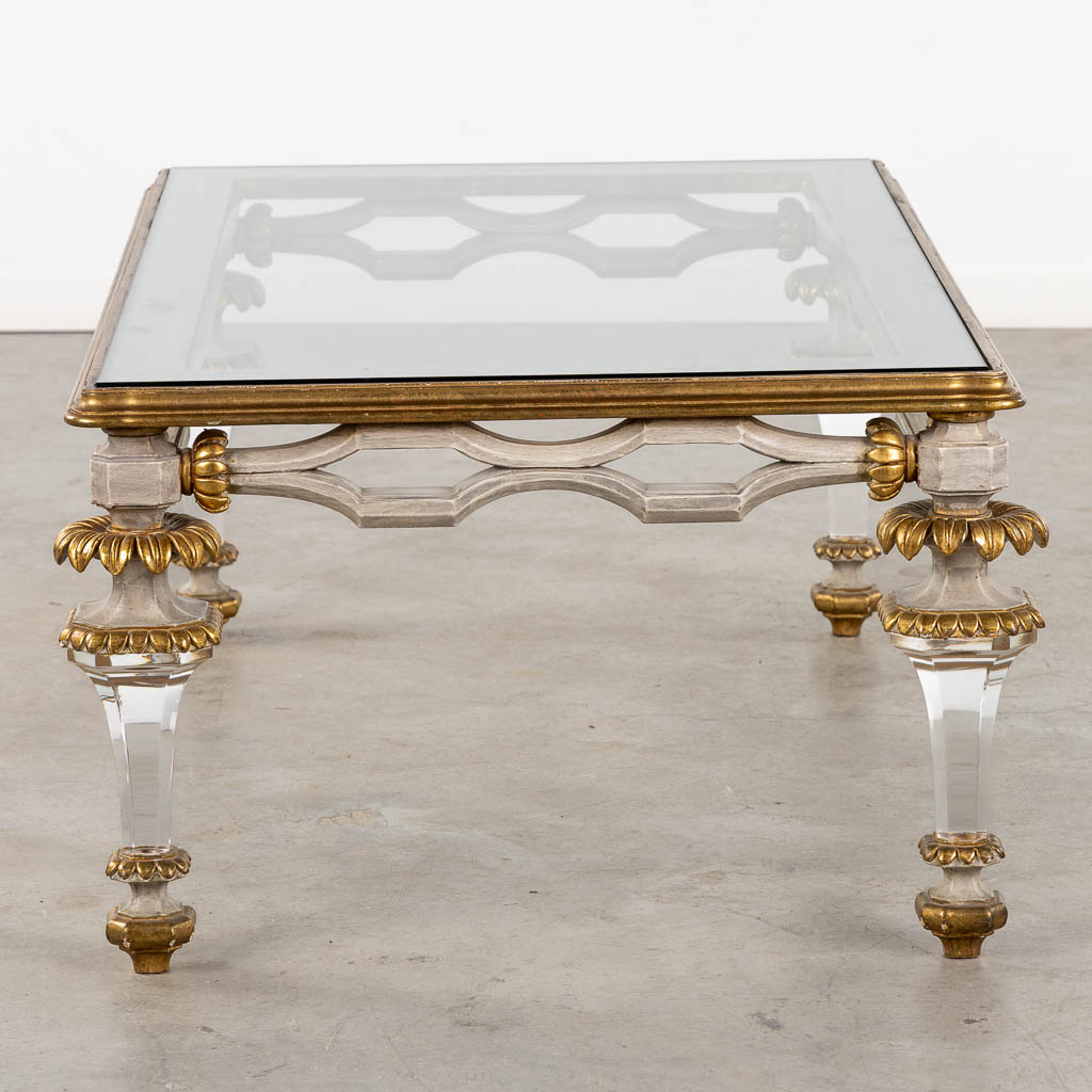 A Hollywood-Regency style coffee table, sculptured wood and plexiglass. (L:73 x W:120 x H:45 cm)