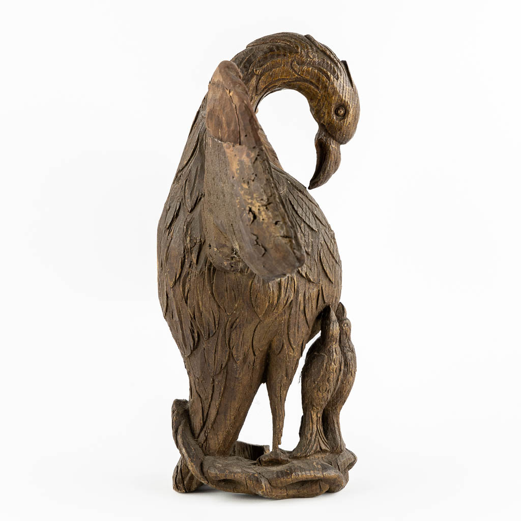 An antique wood-sculptured 'Pelican With Chicks'. 18th/19th C.