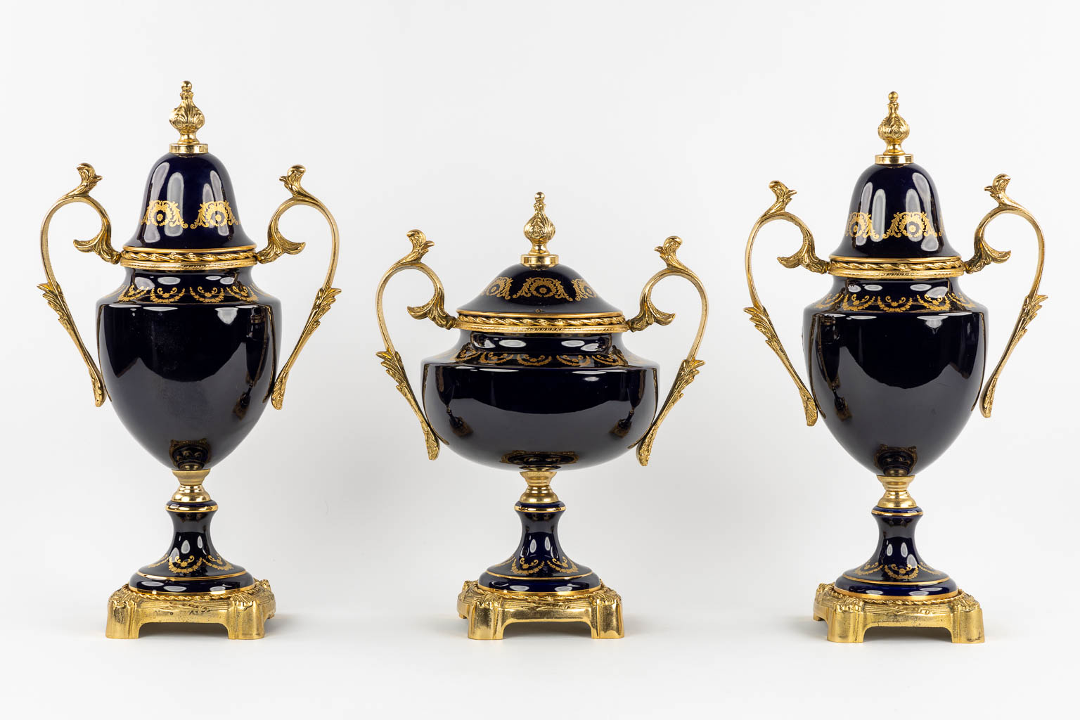 Limoges, a three-piece mantel garniture, porcelain mounted with bronze. 20th C.