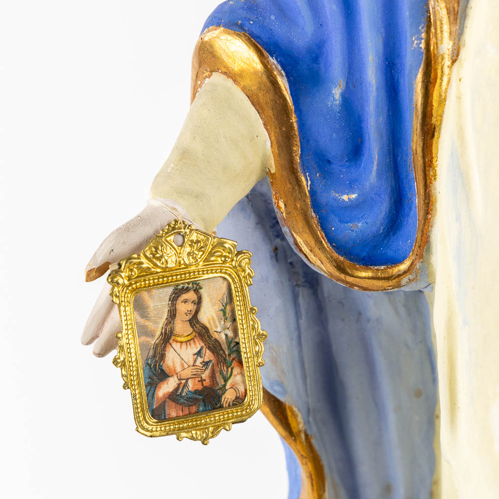 A patinated terracotta figurine of The Virgin Mary. (c1900)