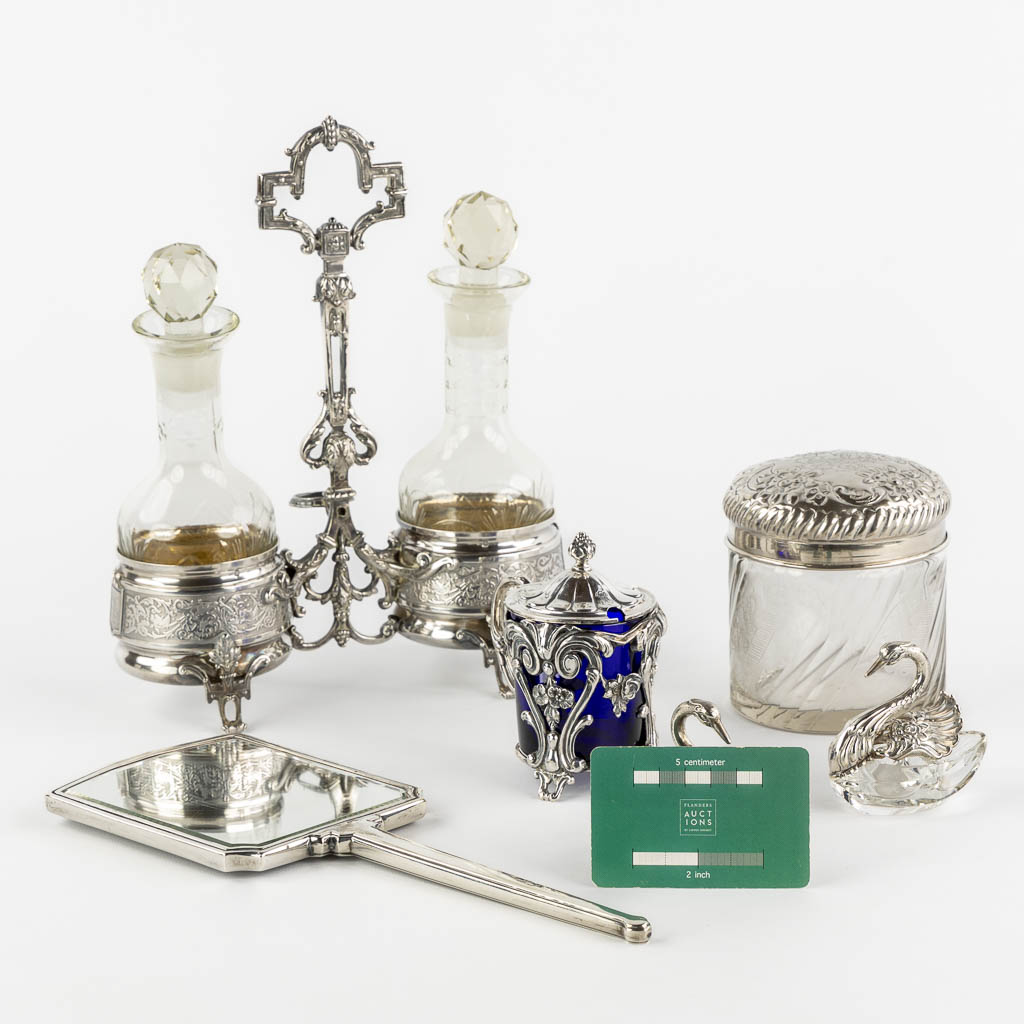 A collection of silver table accessories, oil/vinegar, salt/pepper, mustard pot, and mirror. (L:9 x W:21 x H:26 cm)