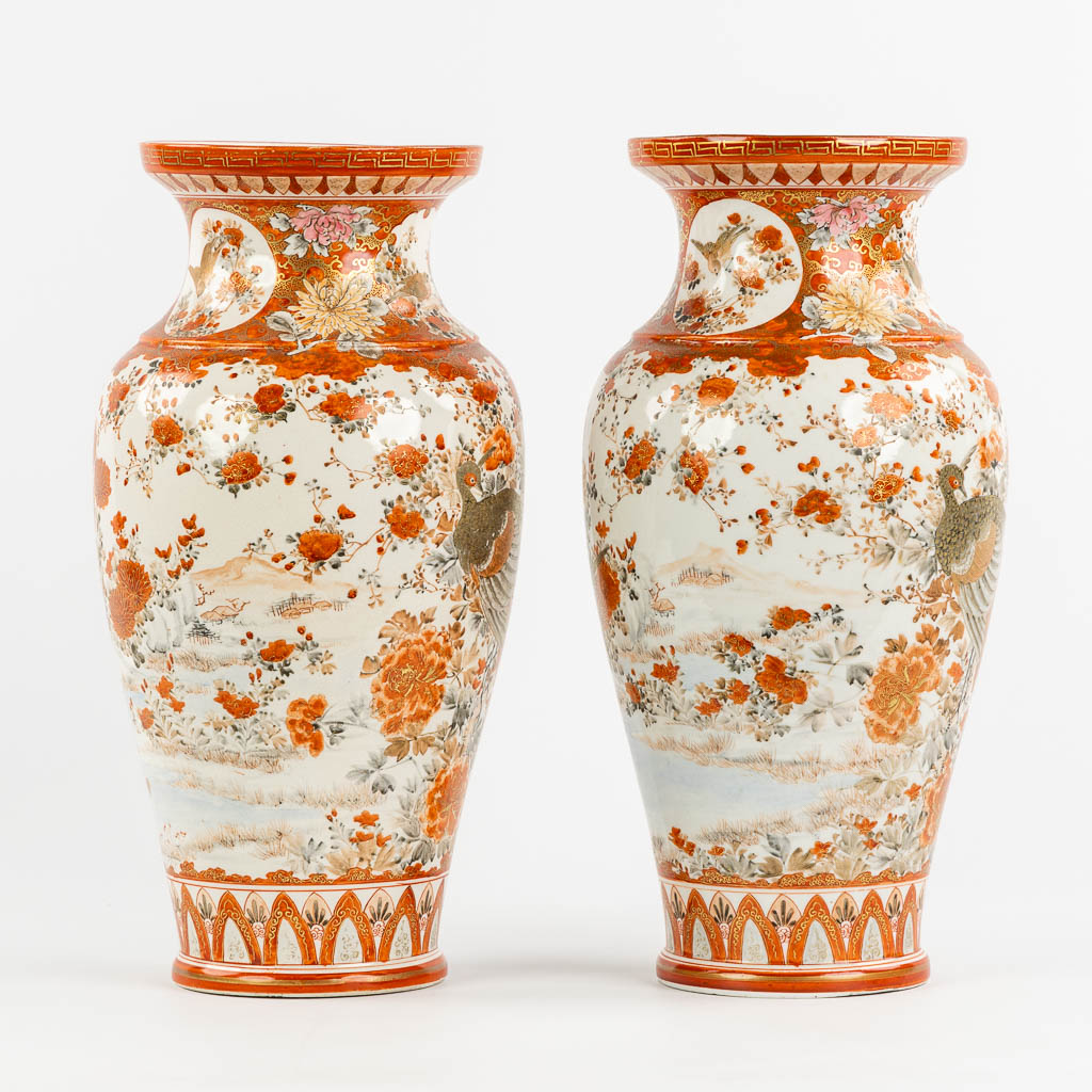 A pair of Japanese Kutani vases, richly finished with a peacock decor. (H:37 x D:19 cm)