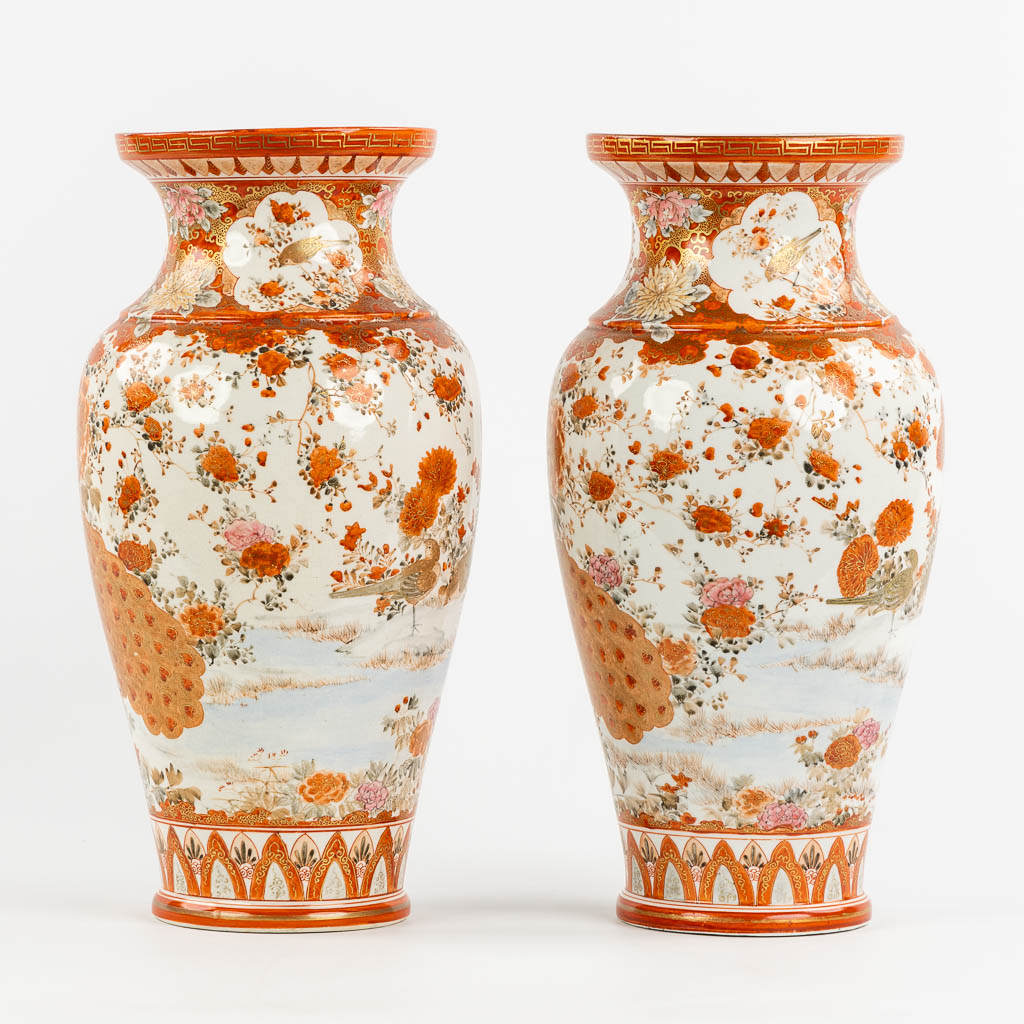 A pair of Japanese Kutani vases, richly finished with a peacock decor. (H:37 x D:19 cm)